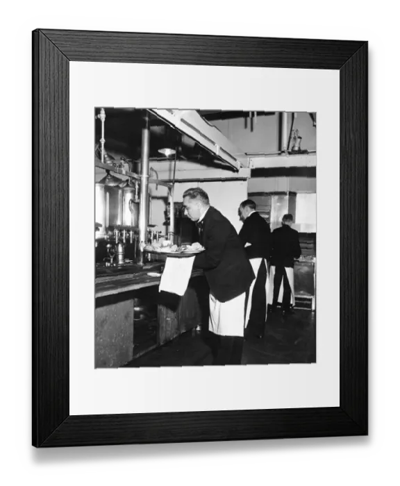 Framed Print : Waiters finish off with tea or coffee as they collect orders during the lunch rush Framed Print : Waiters finish off with tea or coffee as they collect orders during the lunch rush