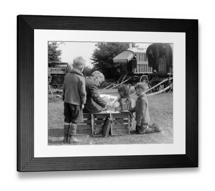 Framed Print : Gypsy children watching a man painting their caravan camp on Epsom Downs, Surrey Framed Print : Gypsy children watching a man painting their caravan camp on Epsom Downs, Surrey