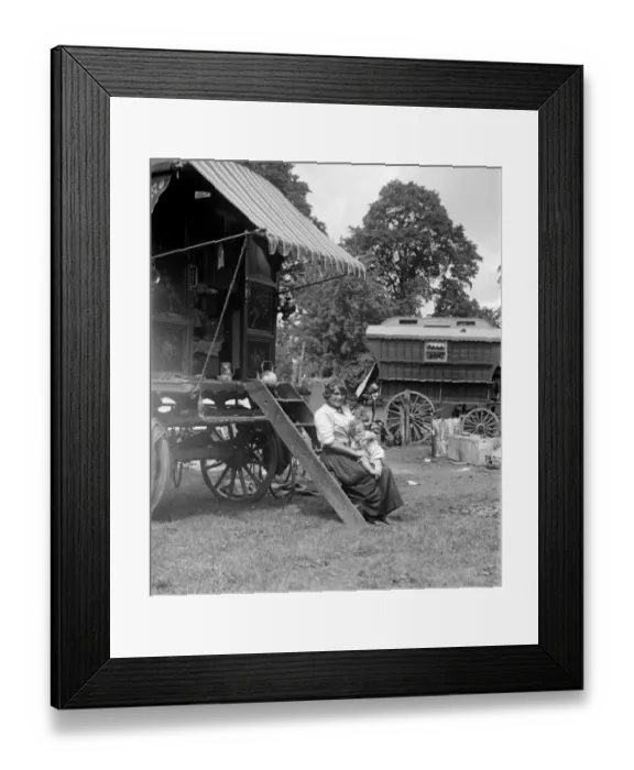 Framed Print : A Romany mother with her baby sitting on the steps of her caravan on Epsom Downs Framed Print : A Romany mother with her baby sitting on the steps of her caravan on Epsom Downs