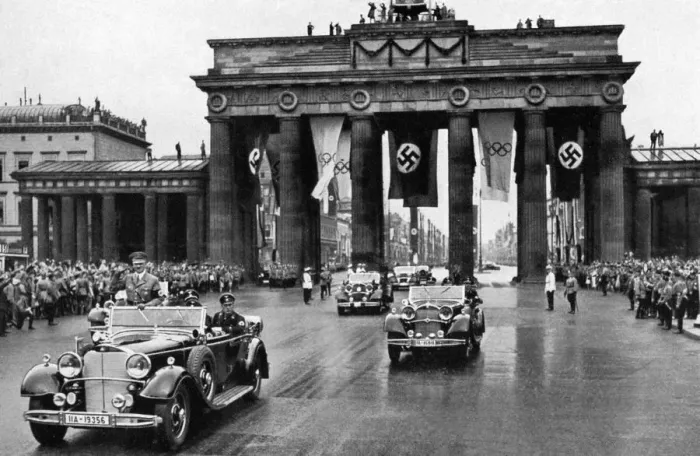 Framed Print : 1936 Olympics, Berlin - Adolf Hitler in an open top car leading a fleet of cars through Framed Print : 1936 Olympics, Berlin - Adolf Hitler in an open top car leading a fleet of cars through
