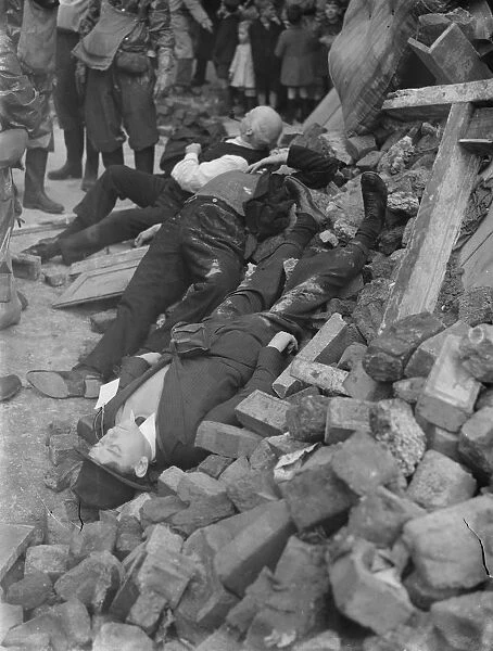 Air Raid Precaution exercise on Old Kent Road in London. Spectators gather round