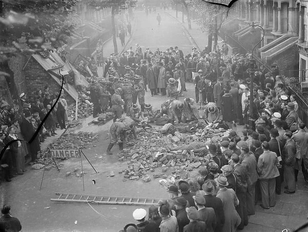 Air Raid Precaution exercise on Old Kent Road in London. Spectators gather round