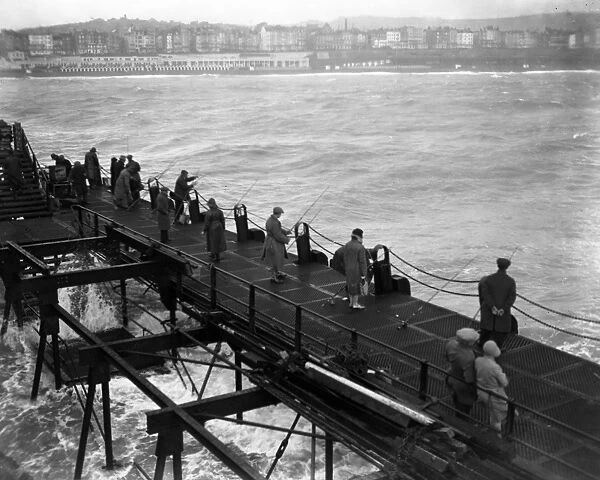Anglers fishing off the West Pier, Brighton, Sussex. 6 October 1929