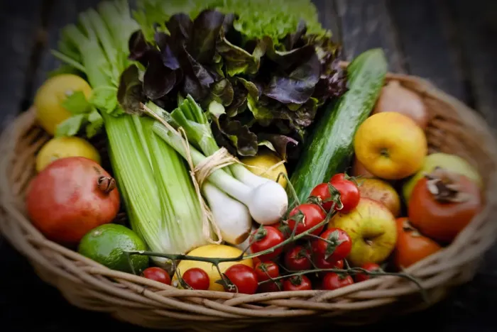 Framed Print : Basket of fresh fruit and vegetables on red surface credit: Marie-Louise Avery Framed Print : Basket of fresh fruit and vegetables on red surface credit: Marie-Louise Avery