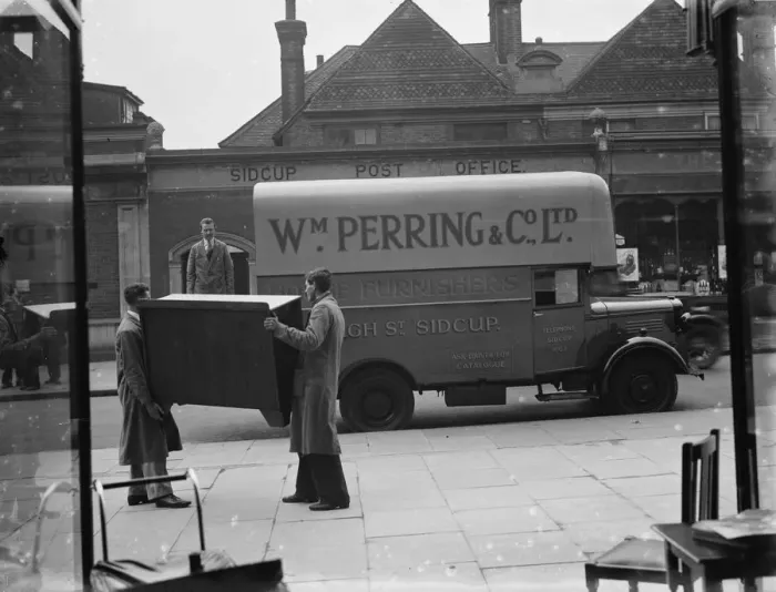 Framed Print : A Bedford truck belonging to W Perring and Co Ltd, the house furnishers. Workers