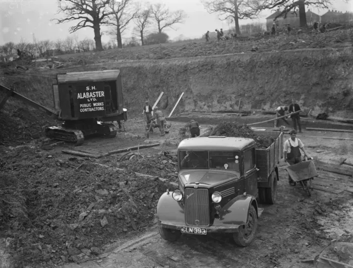 Framed Print : A Bedford truck, full of soil, pulls out of the site where the new swimming pool