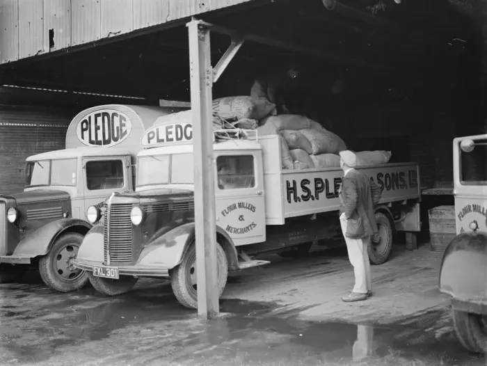Framed Print : Bedford trucks belonging to Pledge & Son Ltd, the milling company, are being loaded Framed Print : Bedford trucks belonging to Pledge & Son Ltd, the milling company, are being loaded