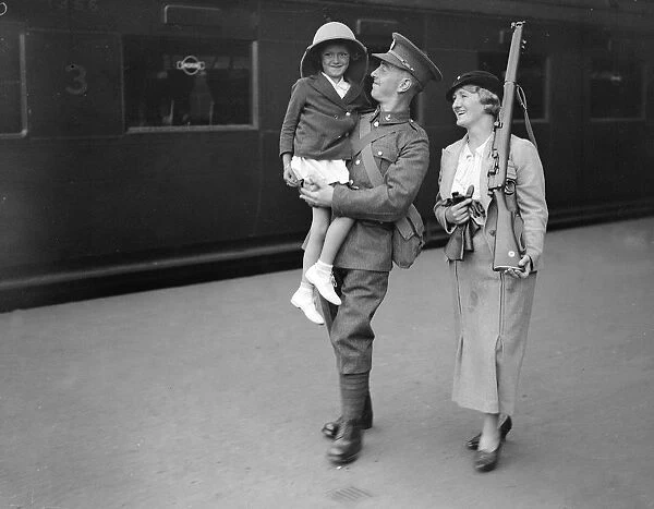 Bidding his daughter and wife goodbye a Royal Engineer ( Postal Section ) off to