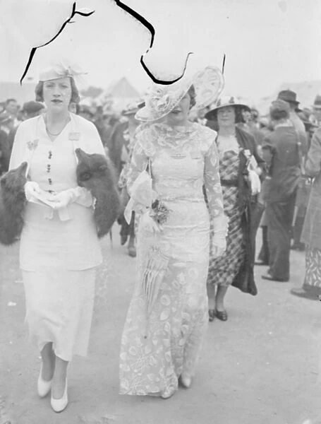 The biggest at Ascot. An outsized hat worn by a women racegoer as she left Waterloo for Ascot