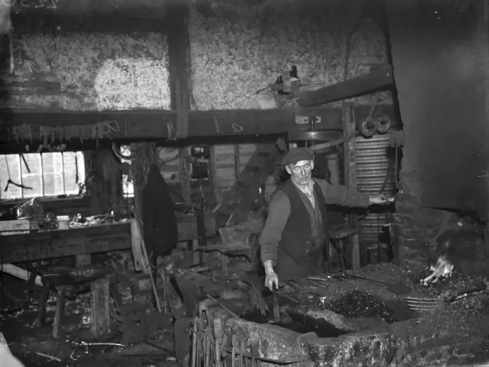 Framed Print : The blacksmith at work in the Westerham Forge. 1935