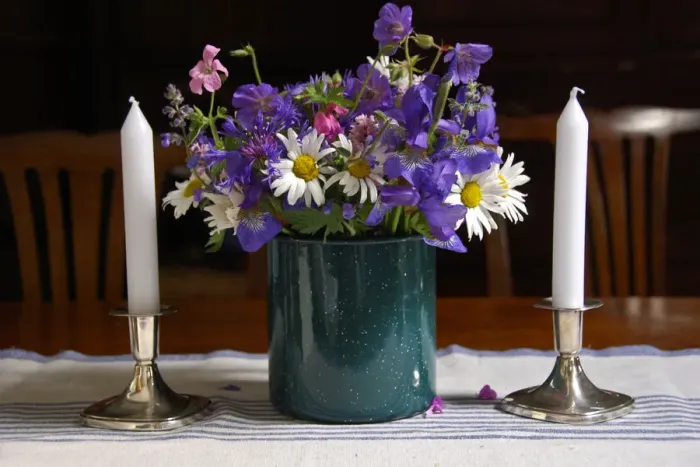 Framed Print : Bouquet of country garden flowers in enamel pot on table with silver candlesticks Framed Print : Bouquet of country garden flowers in enamel pot on table with silver candlesticks