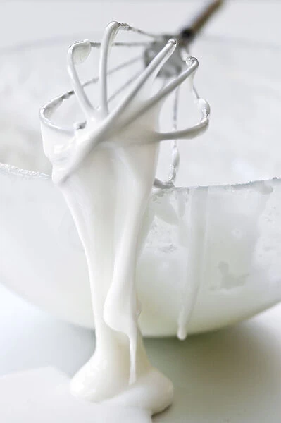 Bowl of white icing with dripping balloon whisk credit: Marie-Louise Avery  /  thePictureKitchen