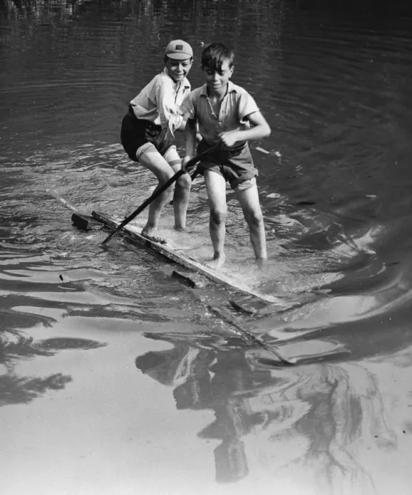 Framed Print : Boys have good fun with an improvised raft on the village pond at Orpington, Kent Framed Print : Boys have good fun with an improvised raft on the village pond at Orpington, Kent