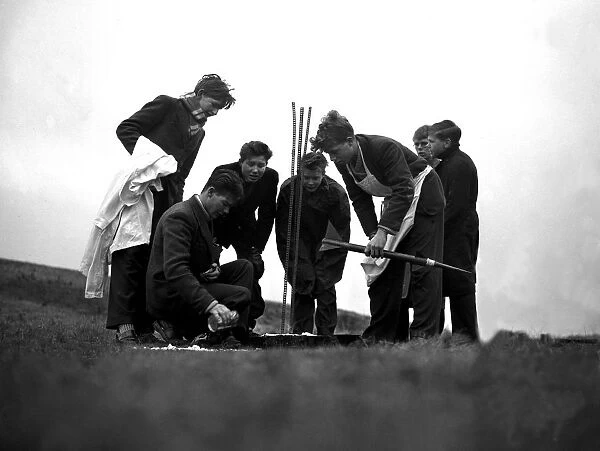 Boys on the Sussex Downs preparing to launch their rocket made from a meccano set. 1959