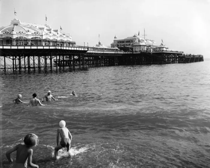 Framed Print : Brighton - enjoying paddling and swimming in the sea near the pier