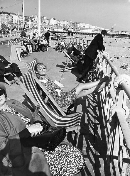 Brighton - enjoying the sunshine sitting in deckchairs on the Promenade at Brighton 28th