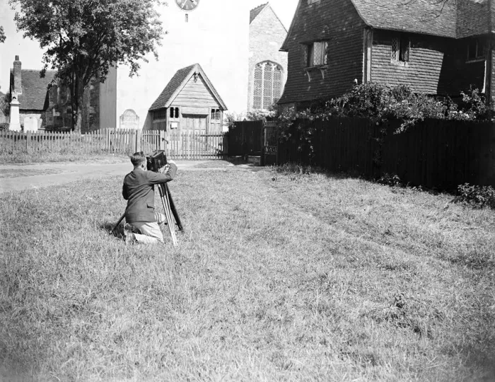 Framed Print : A cameraman filming in front of the village church in Otford, Kent. 1933 Framed Print : A cameraman filming in front of the village church in Otford, Kent. 1933