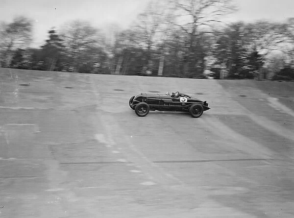 Captain Sir Henry Birkin in his car speeding around the Brooklands track at the