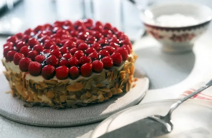 Framed Print : Celebration cream cake toppped with fresh raspberries and with toasted flaked almonds Framed Print : Celebration cream cake toppped with fresh raspberries and with toasted flaked almonds