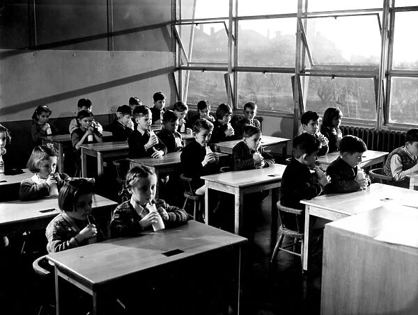 Children drinking milk at school. 1951