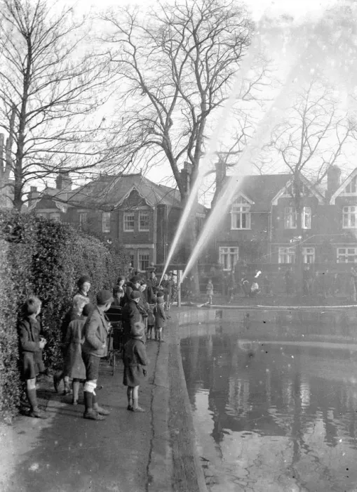 Framed Print : Children watching firemen dealing with flames in Chislehurst, Kent. 1933 Framed Print : Children watching firemen dealing with flames in Chislehurst, Kent. 1933