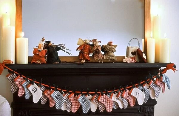 Chimneypiece decorated for Christmas with advent calender made of little xmas stockings