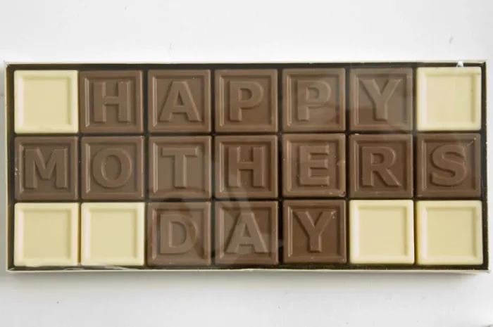 Framed Print : Chocolate letters spelling Happy Mothers Day in cellophane box as Mothers day