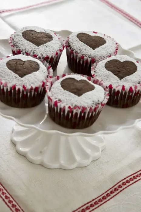 Framed Print : Five chocolate muffins decorated with icing sugar in heart shape on white cake stand credit