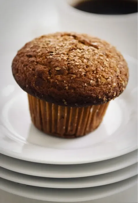 Framed Print : Cinnamon bran muffin on stack of white plates with cup of black coffee credit Framed Print : Cinnamon bran muffin on stack of white plates with cup of black coffee credit