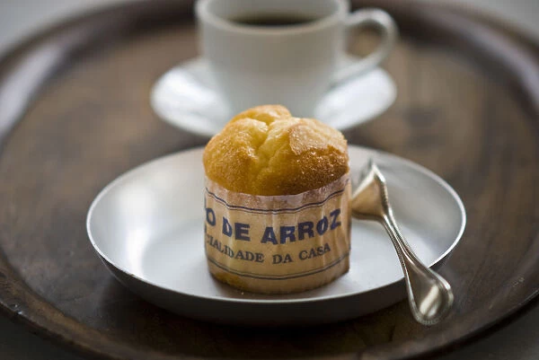 Classic Portuguese muffin type cake made with rice in paper wrapper on metal plate