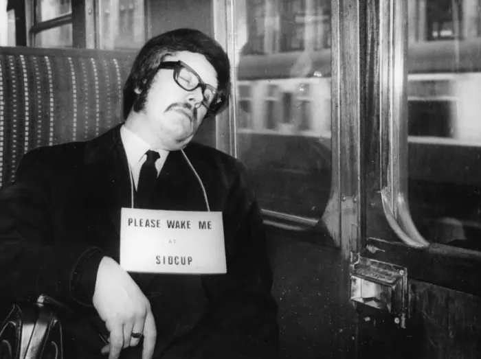 Framed Print : Commuter asleep on the train wearing a sign saying Please wake me up at Sidcup Framed Print : Commuter asleep on the train wearing a sign saying Please wake me up at Sidcup