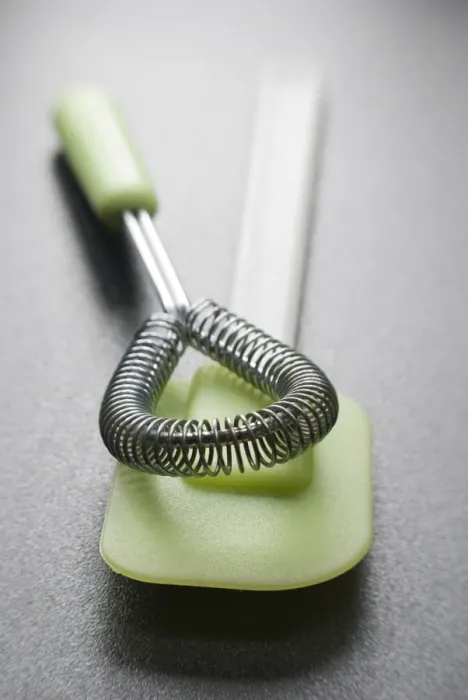 Framed Print : Cookery equipment, , wire whisk and green plastic and silicone spatula credit: Marie-Louise