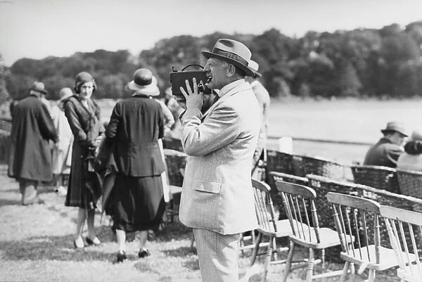 Cowdray Park Polo Week. Viscount Cowdray taking cine pictures of the match. Sussex