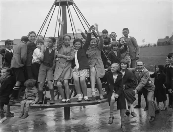 Framed Print : Crayford playground is opened. Children swing on the maypole swing Framed Print : Crayford playground is opened. Children swing on the maypole swing