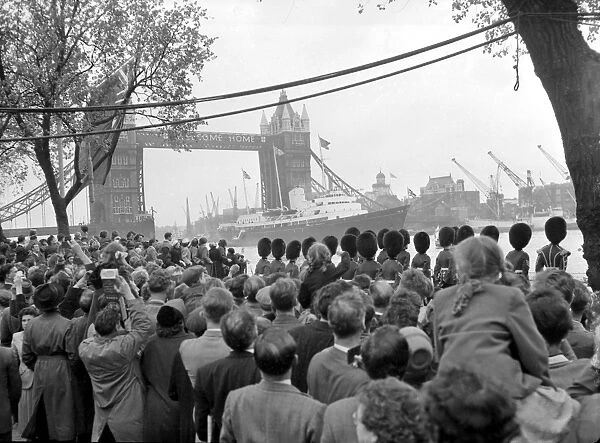 The crowds and guardsmen along the river Thames as through the welcoming Tower Bridge