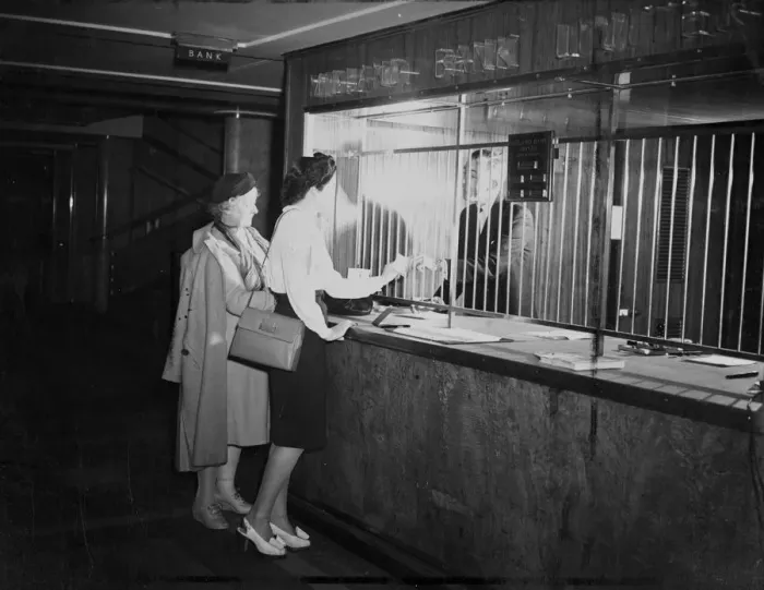 Framed Print : Customers at Midland Bank being attended to by a Bank Teller. 23 October 1946 Framed Print : Customers at Midland Bank being attended to by a Bank Teller. 23 October 1946