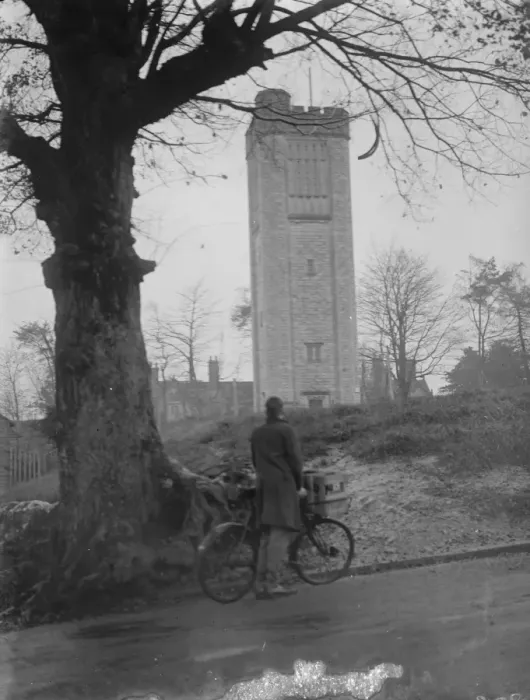 Framed Print : Cyclist looks at a water tower. 1935