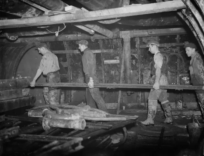 Framed Print : The Dartford tunnel men carrying part of the metal framework to its position Framed Print : The Dartford tunnel men carrying part of the metal framework to its position