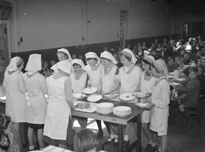Framed Print : Dinner at East Central School in Dartford, Kent. The girls line up their food