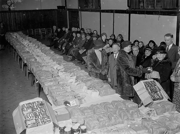 Distributing Christmas parcels for the poor at Chislehurst, Kent. 1935