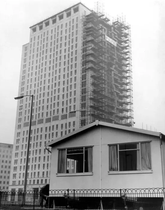 Framed Print : Dwarfed by the new Shell skyscraper is the sun cottage. One of three new portable Framed Print : Dwarfed by the new Shell skyscraper is the sun cottage. One of three new portable
