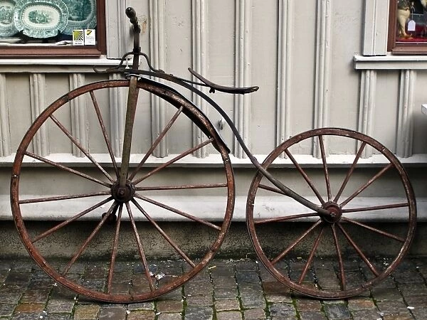 Early bicycle against wooden painted wall of antique shop in Haga district of Gothenburg
