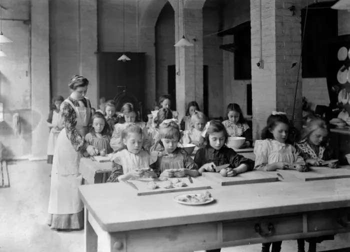 Framed Print : Edwardian school. Young girls, in the classroom, being supervised by their teacher Framed Print : Edwardian school. Young girls, in the classroom, being supervised by their teacher