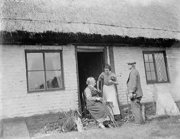 The elderly inhabitants of the thatched cottages in Bredgar, Kent, sitting outside