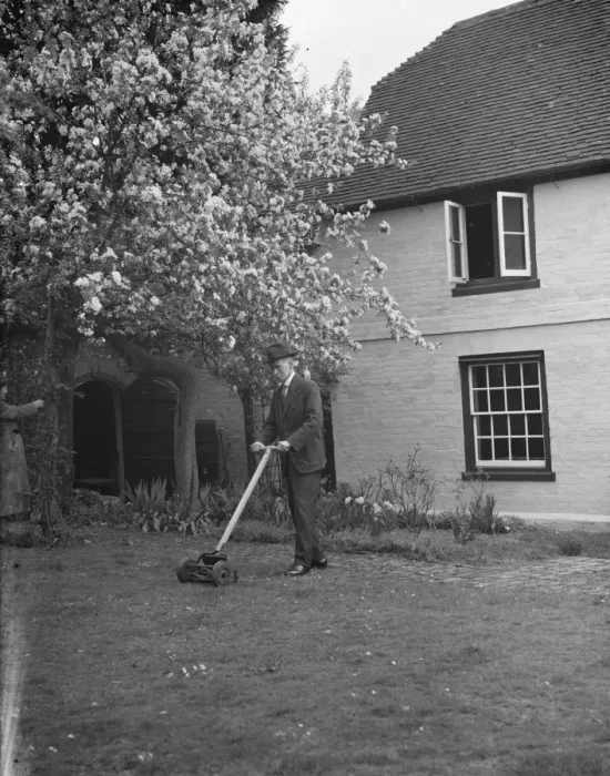 Framed Print : An elderly man cuts the grass at his cottage garden in Farningham, Kent. 7 April 1938 Framed Print : An elderly man cuts the grass at his cottage garden in Farningham, Kent. 7 April 1938