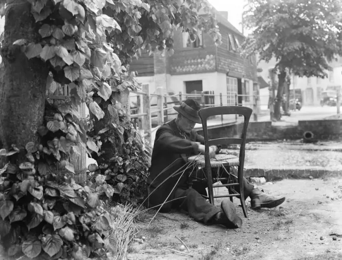 Framed Print : An elderly man fixes the seat of a chair with wicker. 1936 Framed Print : An elderly man fixes the seat of a chair with wicker. 1936