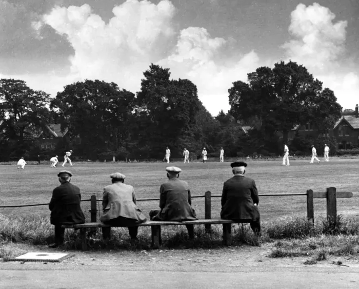 Framed Print : Elderly men sitting on a bench watching a local cricket match