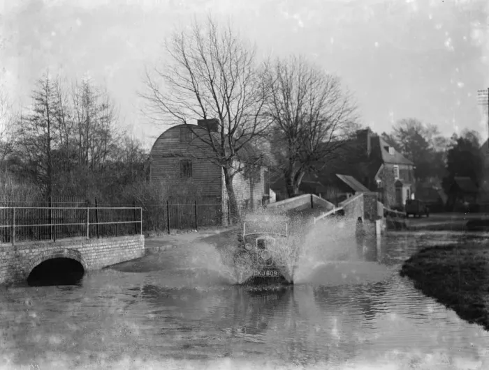 Framed Print : Eynsford Bridge flooded. A car ploughs through the water. 1937