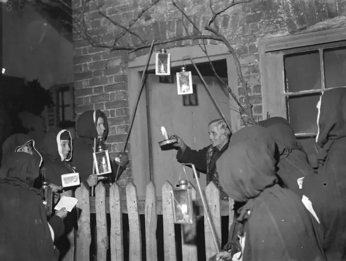 Framed Print : An Eynsford resident has a visit from hooded carol singers. 1935