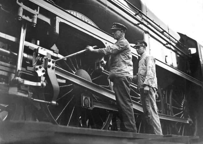 Framed Print : F C Bishop the driver of the Royal Scot ands Banting checking the engine before